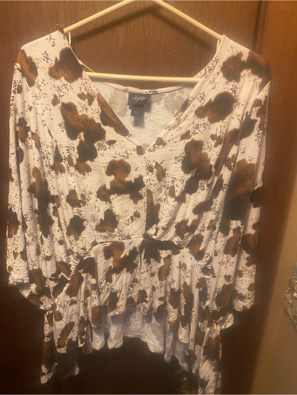 Daytrip Buckle Cow Print Top,” “XXL V-neck